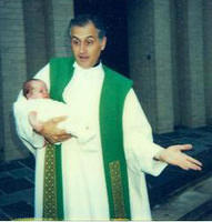 Fr. Troncali holding Megan
